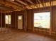 Interior framing of a room under construction, featuring a door and large window at 30 Seahawk Way, Zebulon, NC 27597