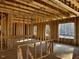Interior framing of a room under construction, showing large windows at 30 Seahawk Way, Zebulon, NC 27597