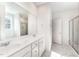 Double vanity bathroom with marble-look tile flooring and shower at 339 Suhani Ln, Clayton, NC 27520