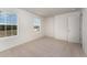 Bright bedroom with neutral carpeting, large windows, and ample closet space at 339 Suhani Ln, Clayton, NC 27520