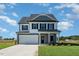 Two-story house with gray siding, white trim, and a two-car garage at 339 Suhani Ln, Clayton, NC 27520