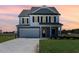 Stunning two-story home with gray siding, white trim, and a welcoming front porch at 339 Suhani Ln, Clayton, NC 27520