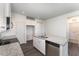 White kitchen with granite island, stainless steel appliances, and ample counter space at 339 Suhani Ln, Clayton, NC 27520