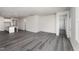 Open concept living space with gray flooring and access to kitchen and hallway at 339 Suhani Ln, Clayton, NC 27520