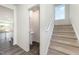 Modern staircase with carpet runner and powder room at 339 Suhani Ln, Clayton, NC 27520