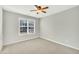 Well-lit bedroom with ceiling fan and large window at 3727 Votive Ln, Raleigh, NC 27604