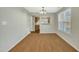 Dining room with hardwood floors, neutral walls, and a chandelier at 3727 Votive Ln, Raleigh, NC 27604