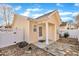Tan house exterior with covered patio and stone pathway at 3727 Votive Ln, Raleigh, NC 27604