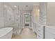 Bright bathroom showcasing a freestanding tub, glass shower, and dual sink vanity with ample storage at 3912 Cedar Knolls Dr, Youngsville, NC 27596