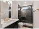 Modern bathroom featuring a glass shower with black tile, gold fixtures, and elegant vanity at 3912 Cedar Knolls Dr, Youngsville, NC 27596