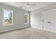 Bright bedroom featuring neutral walls, carpeted floors, ceiling fan, and windows providing natural light at 3912 Cedar Knolls Dr, Youngsville, NC 27596