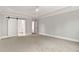 Expansive bedroom with a modern ceiling fan, neutral walls, and a sliding barn door at 3912 Cedar Knolls Dr, Youngsville, NC 27596