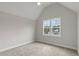 Vaulted ceiling bedroom with carpet floors, updated ceiling fan, and windows with a view at 3912 Cedar Knolls Dr, Youngsville, NC 27596