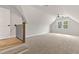 Bonus room features neutral walls, carpet, fan, and natural light from windows at 3912 Cedar Knolls Dr, Youngsville, NC 27596
