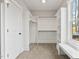 Bright walk-in closet with built-in shelving, rods for hanging clothes, and bench seating by a window at 3912 Cedar Knolls Dr, Youngsville, NC 27596