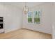 Dining room with shiplap walls, hardwood floors, a modern light fixture and natural light from two windows at 3912 Cedar Knolls Dr, Youngsville, NC 27596
