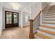 Bright foyer showcases hardwood floors, a staircase with black iron railings, and a front door at 3912 Cedar Knolls Dr, Youngsville, NC 27596