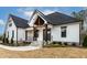 Inviting single-story home boasting a covered porch with stone accents and a well-manicured lawn at 3912 Cedar Knolls Dr, Youngsville, NC 27596