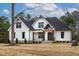 Beautiful two-story modern farmhouse-style home with a manicured lawn and inviting front porch at 3912 Cedar Knolls Dr, Youngsville, NC 27596