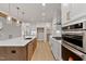 Spacious kitchen with stainless steel appliances, quartz countertops, custom cabinets, and hardwood floors at 3912 Cedar Knolls Dr, Youngsville, NC 27596