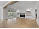 Bright living room featuring a fireplace, hardwood floors, beamed ceilings and access to the screened-in porch at 3912 Cedar Knolls Dr, Youngsville, NC 27596