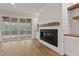 Bright living room with hardwood floors, a fireplace, and access to the screened-in porch at 3912 Cedar Knolls Dr, Youngsville, NC 27596
