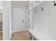 Bright mudroom with built-in bench, coat hooks, and storage, connecting to the home's entrance at 3912 Cedar Knolls Dr, Youngsville, NC 27596