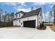 Modern farmhouse-style home with a large driveway leading to an attached two-car garage at 3912 Cedar Knolls Dr, Youngsville, NC 27596