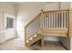 Unfinished wood staircase leading to a second story or loft with black metal balusters at 3912 Cedar Knolls Dr, Youngsville, NC 27596