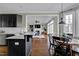 Modern kitchen features dark cabinetry, stainless steel appliances, and a breakfast bar at 5417 Leopards Bane Ct, Holly Springs, NC 27540