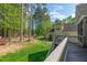 Backyard with a spacious lawn, mature trees, and a deck, perfect for outdoor enjoyment at 7320 Dunsany Ct, Wake Forest, NC 27587