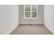 Bright bedroom showcases neutral carpet and white walls, offering a serene space with natural light at 7320 Dunsany Ct, Wake Forest, NC 27587