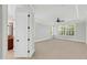 Large primary bedroom features tray ceilings, plush carpeting, and a view of the backyard at 7320 Dunsany Ct, Wake Forest, NC 27587