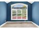 Cozy bedroom featuring neutral carpet and an arched window with great natural light and private views at 7320 Dunsany Ct, Wake Forest, NC 27587