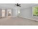 Spacious primary bedroom with natural light, plush carpeting, and an en-suite bathroom at 7320 Dunsany Ct, Wake Forest, NC 27587