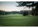 The clubhouse is surrounded by a lush green landscape, golf course, and mature trees at 7320 Dunsany Ct, Wake Forest, NC 27587