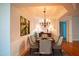 The formal dining room offers a chandelier, wainscoting, and seating for six; great for entertaining at 7320 Dunsany Ct, Wake Forest, NC 27587