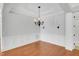 Large dining room with hardwood floors, wainscoting, a chandelier, and sconce lighting at 7320 Dunsany Ct, Wake Forest, NC 27587