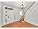 Bright foyer with hardwood floors, a staircase, and a white front door with transom window at 7320 Dunsany Ct, Wake Forest, NC 27587