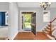 Bright foyer featuring hardwood floors, a staircase, and an open view to the front yard at 7320 Dunsany Ct, Wake Forest, NC 27587