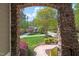 View of a lovely front yard and home through the stone archway of the front entrance at 7320 Dunsany Ct, Wake Forest, NC 27587
