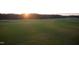 Scenic golf course view features lush green fairways, sand traps and a beautiful sunset backdrop at 7320 Dunsany Ct, Wake Forest, NC 27587