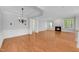 Open-concept living space with hardwood flooring, a fireplace, and large windows for ample natural light at 7320 Dunsany Ct, Wake Forest, NC 27587
