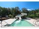 Relax in the pool with a slide feature in a serene, treelined environment with lounge seating for relaxation at 7320 Dunsany Ct, Wake Forest, NC 27587