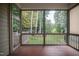 Inviting screened porch offering serene views of lush greenery and the surrounding landscape at 7320 Dunsany Ct, Wake Forest, NC 27587