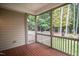 Relaxing screened porch with wood flooring, overlooking a lush, green backyard at 7320 Dunsany Ct, Wake Forest, NC 27587
