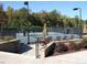 Community tennis courts feature shaded seating and landscaping creating a relaxing environment for spectators at 7320 Dunsany Ct, Wake Forest, NC 27587