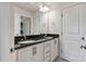 Bathroom features a double sink vanity with black granite countertop and white cabinets at 8217 Cannon Grove Dr, Willow Springs, NC 27592