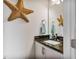Half bath with granite vanity, white cabinets, and decorative starfish at 8217 Cannon Grove Dr, Willow Springs, NC 27592