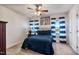 Bedroom with a queen bed, ceiling fan, and large window at 8217 Cannon Grove Dr, Willow Springs, NC 27592